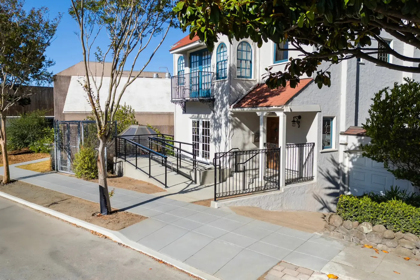 Wider establishing shot, ADA ramp + driveway apron — ADA Ramp & Sidewalk — West Portal, West Portal, San Francisco