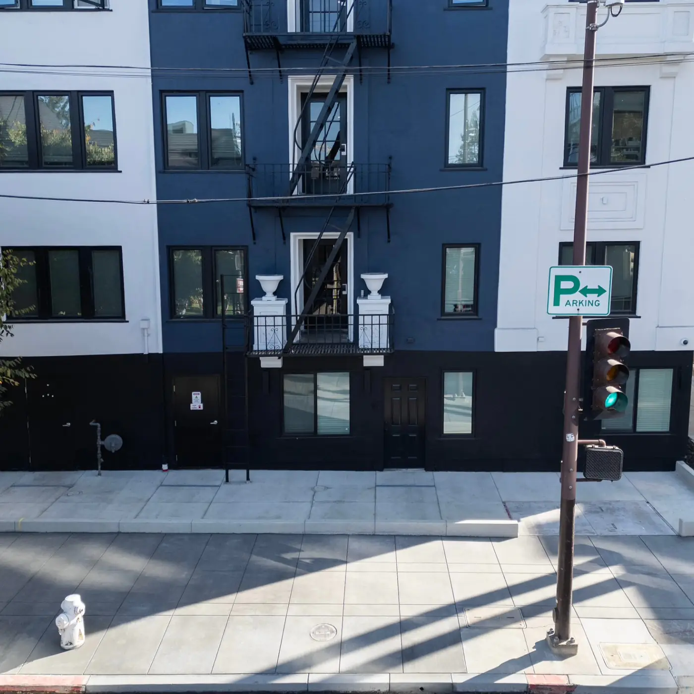 Frontal building view, new sidewalk + curb at corner — Durant Sidewalk — UC Berkeley, Berkeley, CA