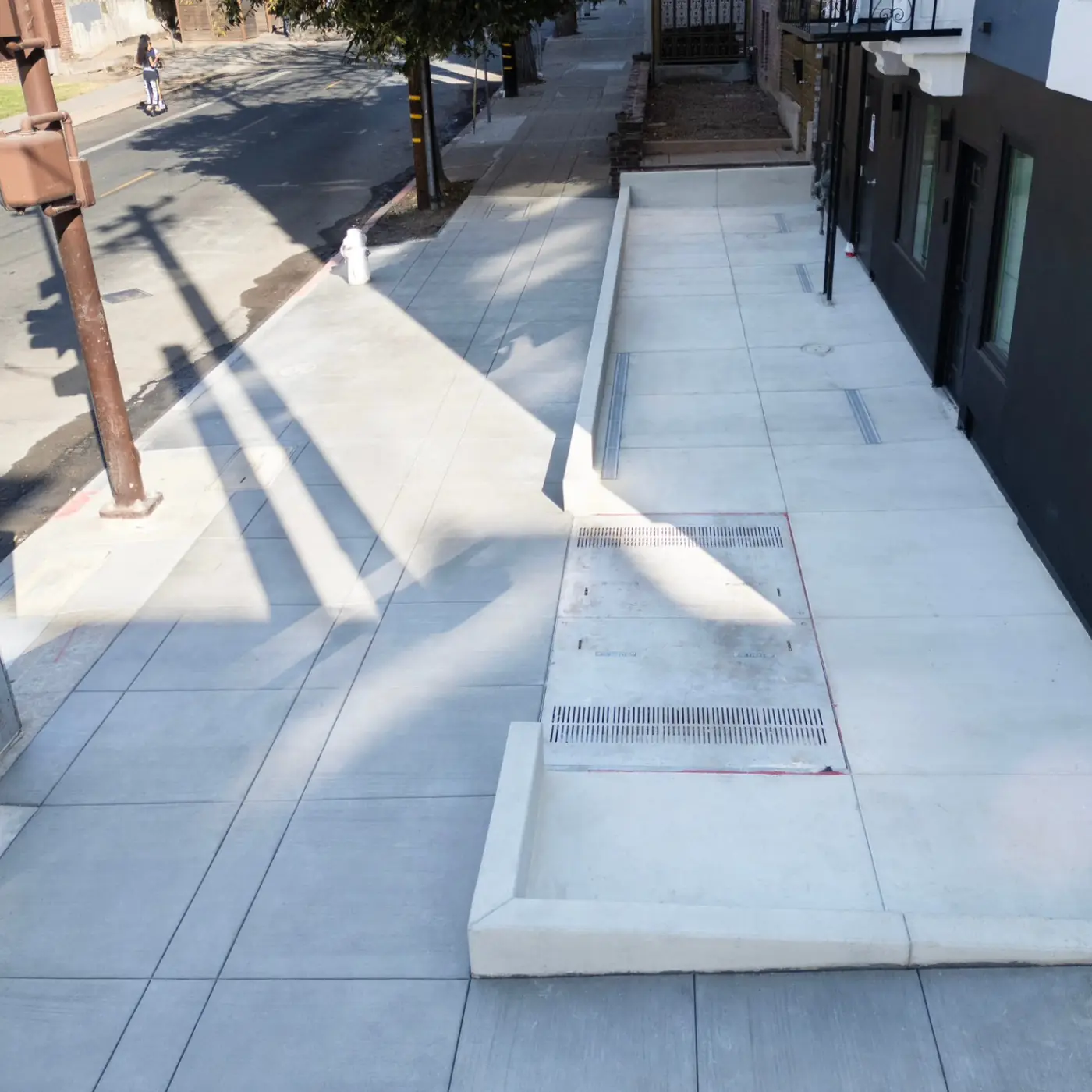 Driveway apron with a channel drain tied into the new sidewalk — Berkeley