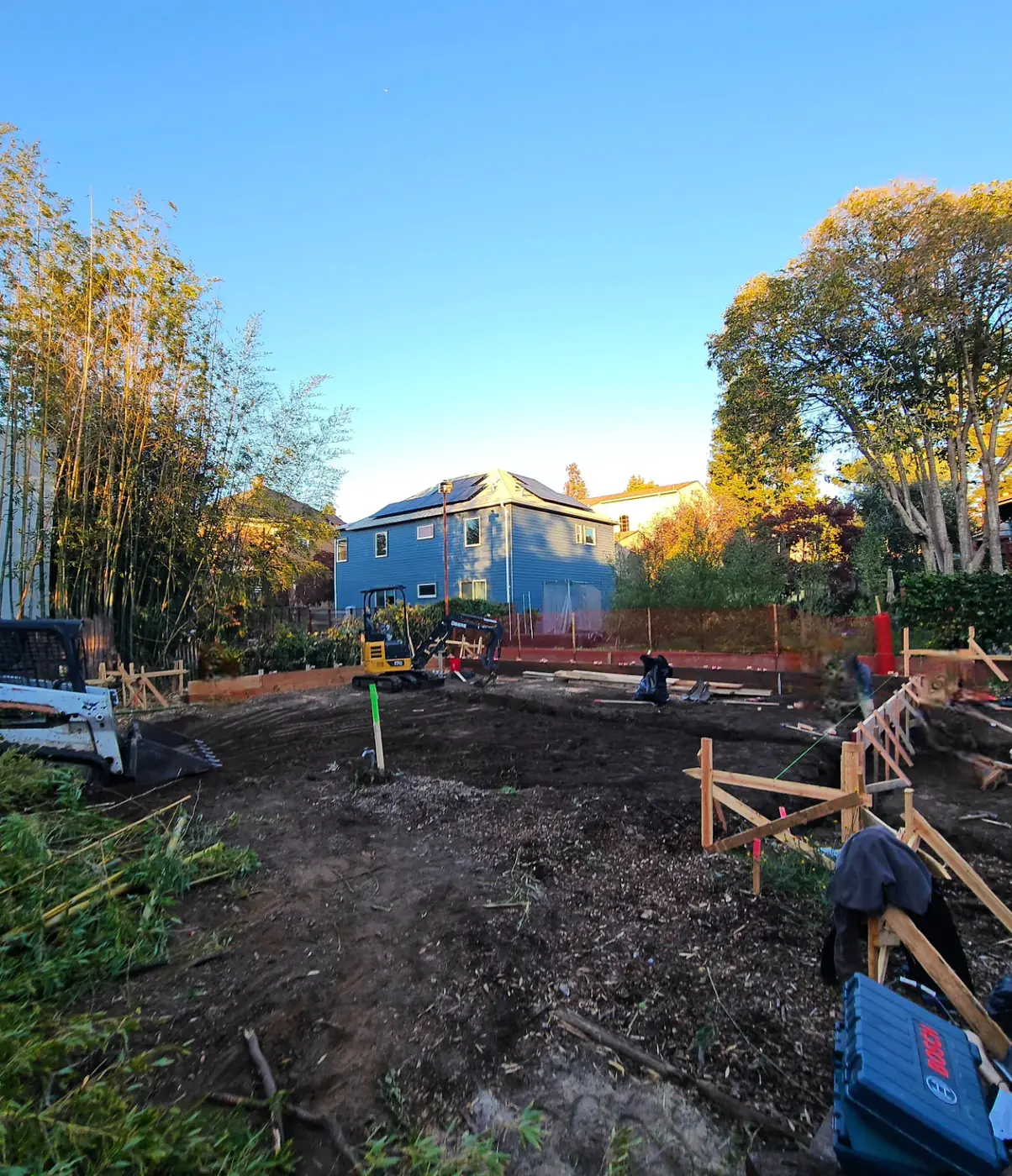 Excavated graded site, golden hour — ADU Foundations — Two Projects, SF Bay Area