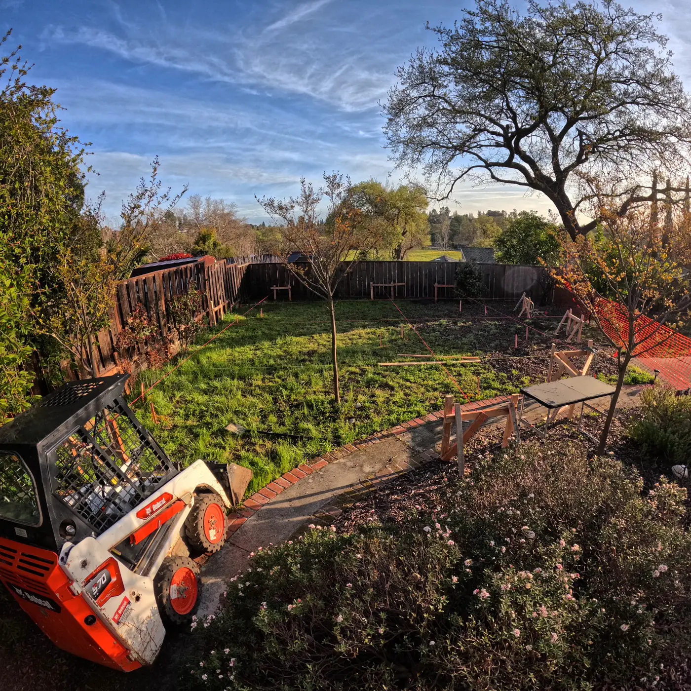 Aerial pre-excavation w/ skid-steer, golden hour — Pleasant Hill ADU Foundation, Pleasant Hill, CA