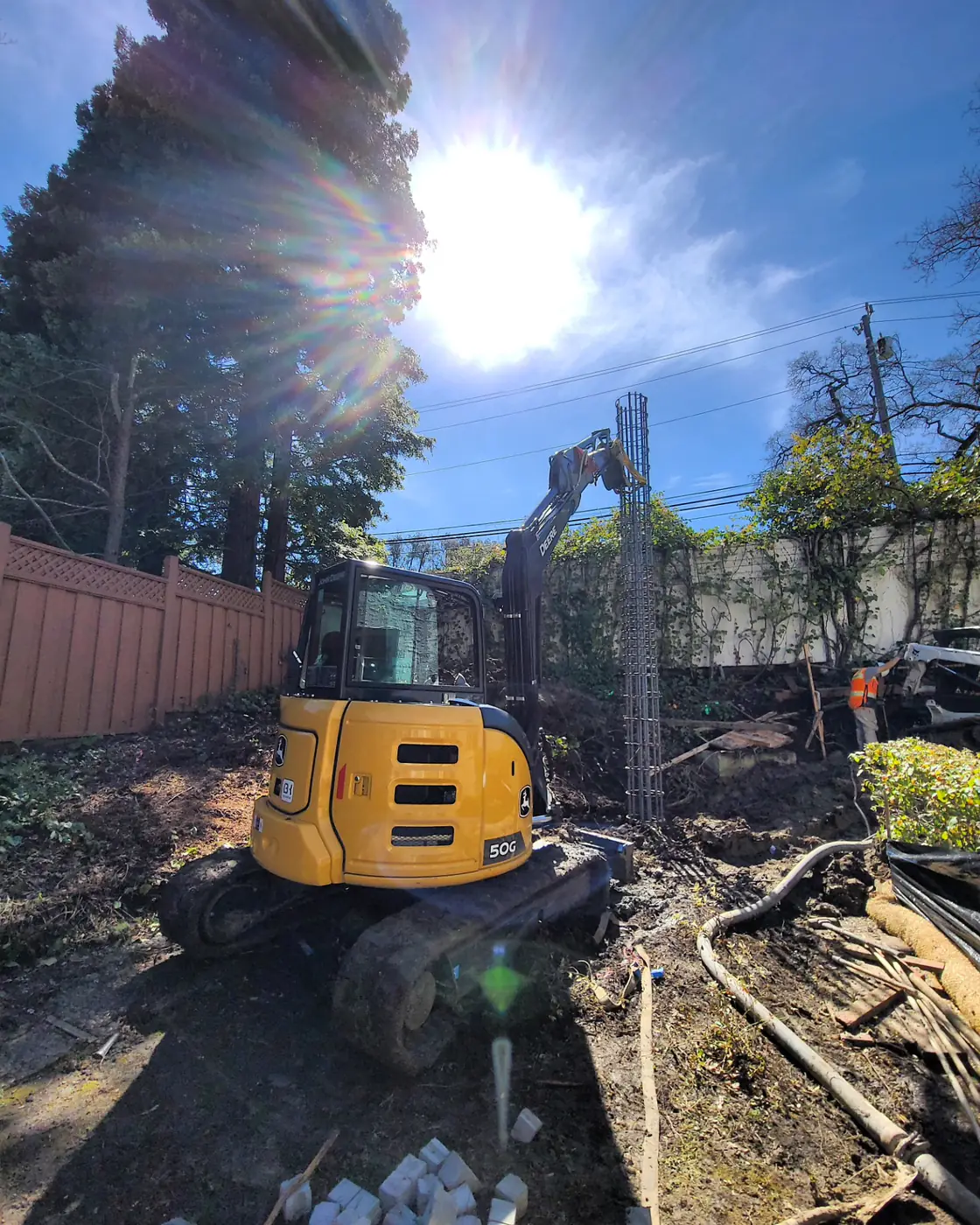 Mini excavator w/ sun flare, rebar piers — Sound Wall Replacement — Diablo Country Club, Danville, CA