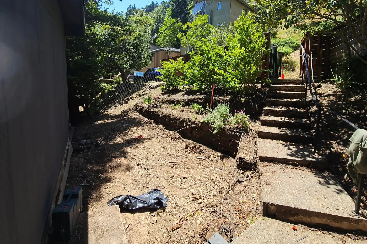 BEFORE: bare dirt slope, old wood stair framing — Hillside Outdoor Living Transformation, Oakland, CA