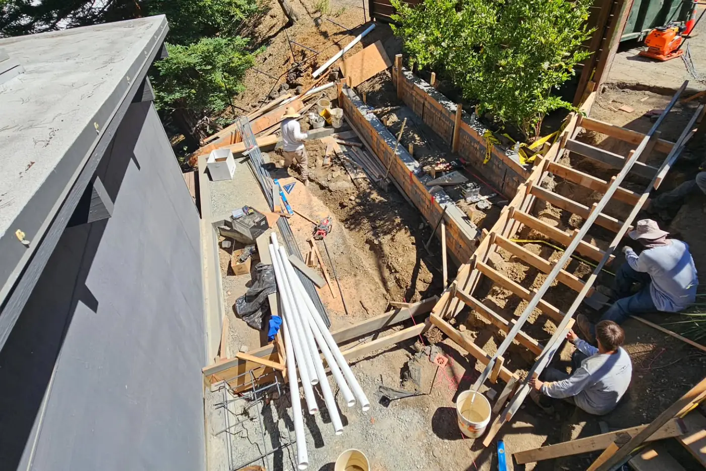 Workers building formwork for stairs/wall — Hillside Outdoor Living Transformation, Oakland, CA