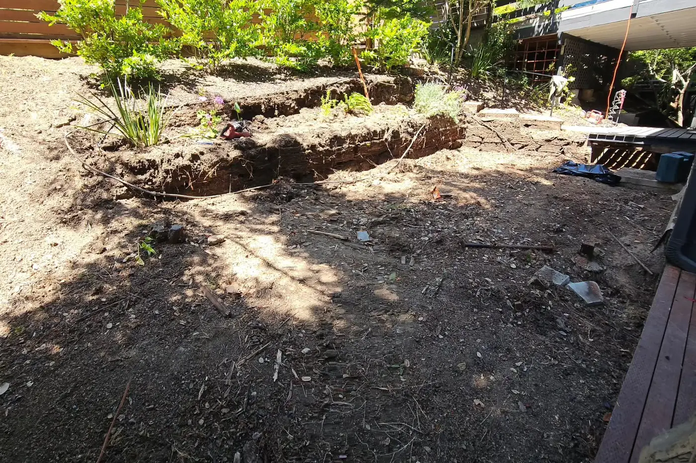 BEFORE: pre-construction bare dirt yard — Hillside Outdoor Living Transformation, Oakland, CA