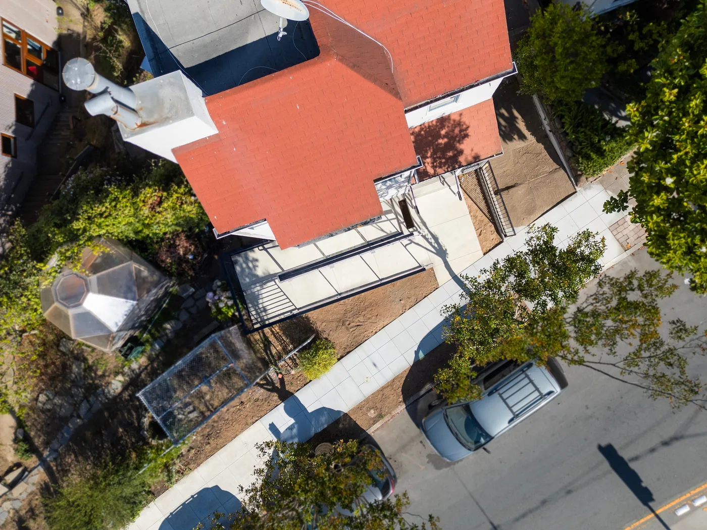 Straight-down aerial of the finished walkway, ramp, and new sidewalk wrapping the building — ADA Ramp & Sidewalk — West Portal, West Portal, San Francisco
