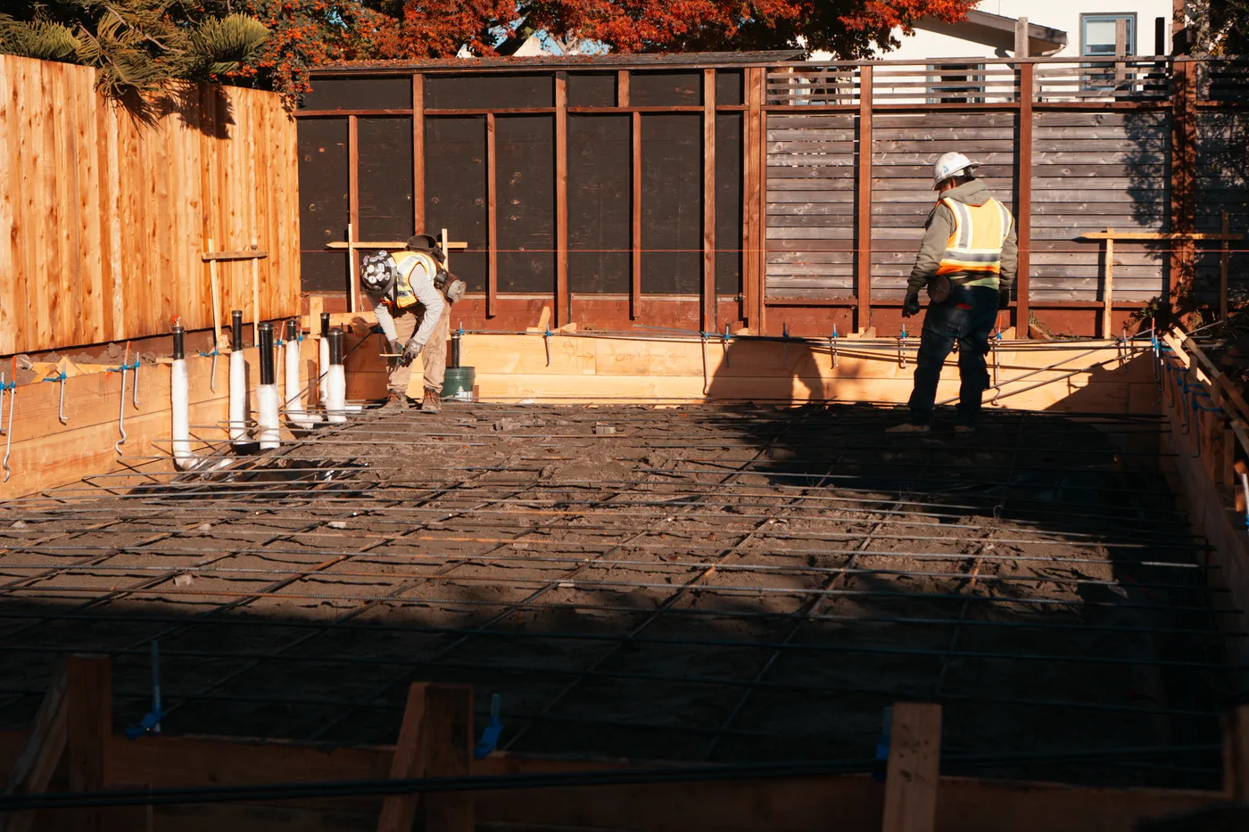 Crew setting underslab plumbing stub-ups and rebar inside the forms before the pour — Berkeley Backyard Detached ADU, Berkeley, CA