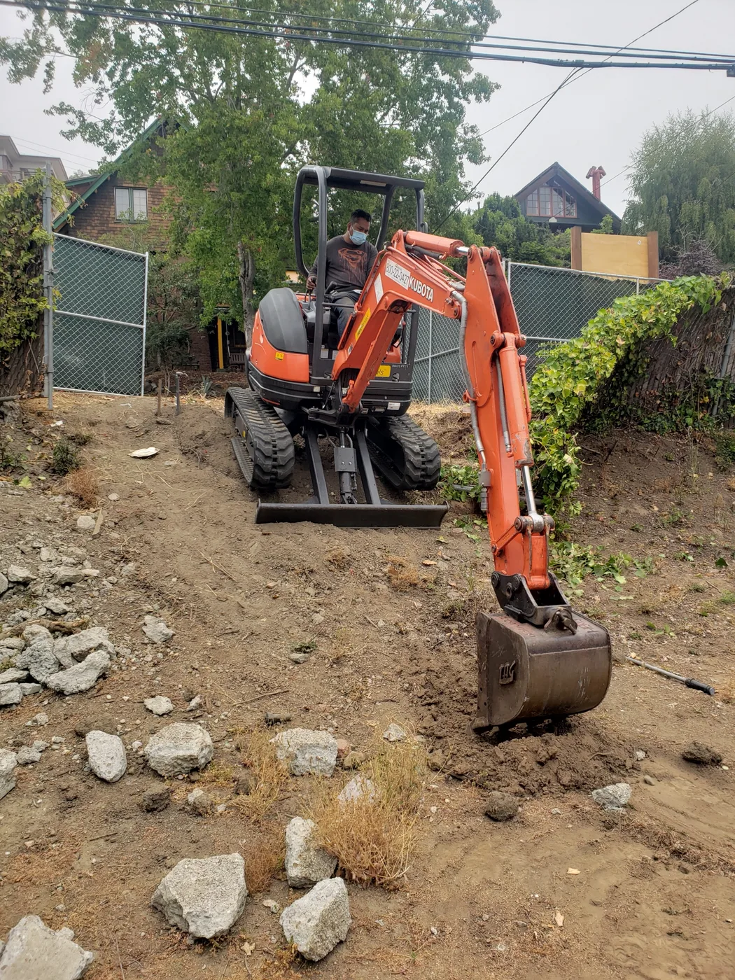 Mini-excavator starting the dig on the tight urban lot — Berkeley Student Housing Foundation, Berkeley, CA