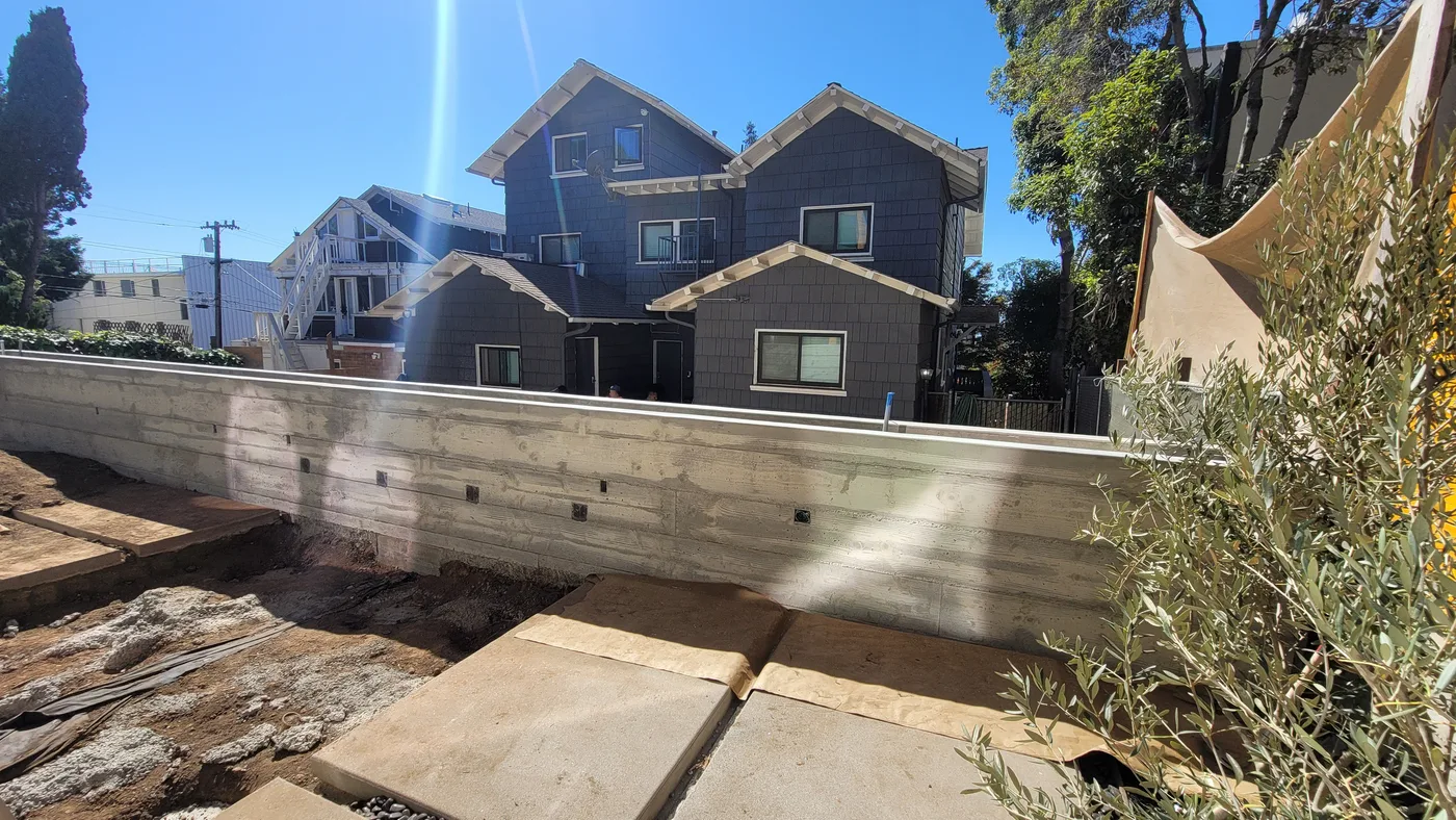 Retaining wall running the length of the lot, building behind — Berkeley Student Housing Foundation, Berkeley, CA