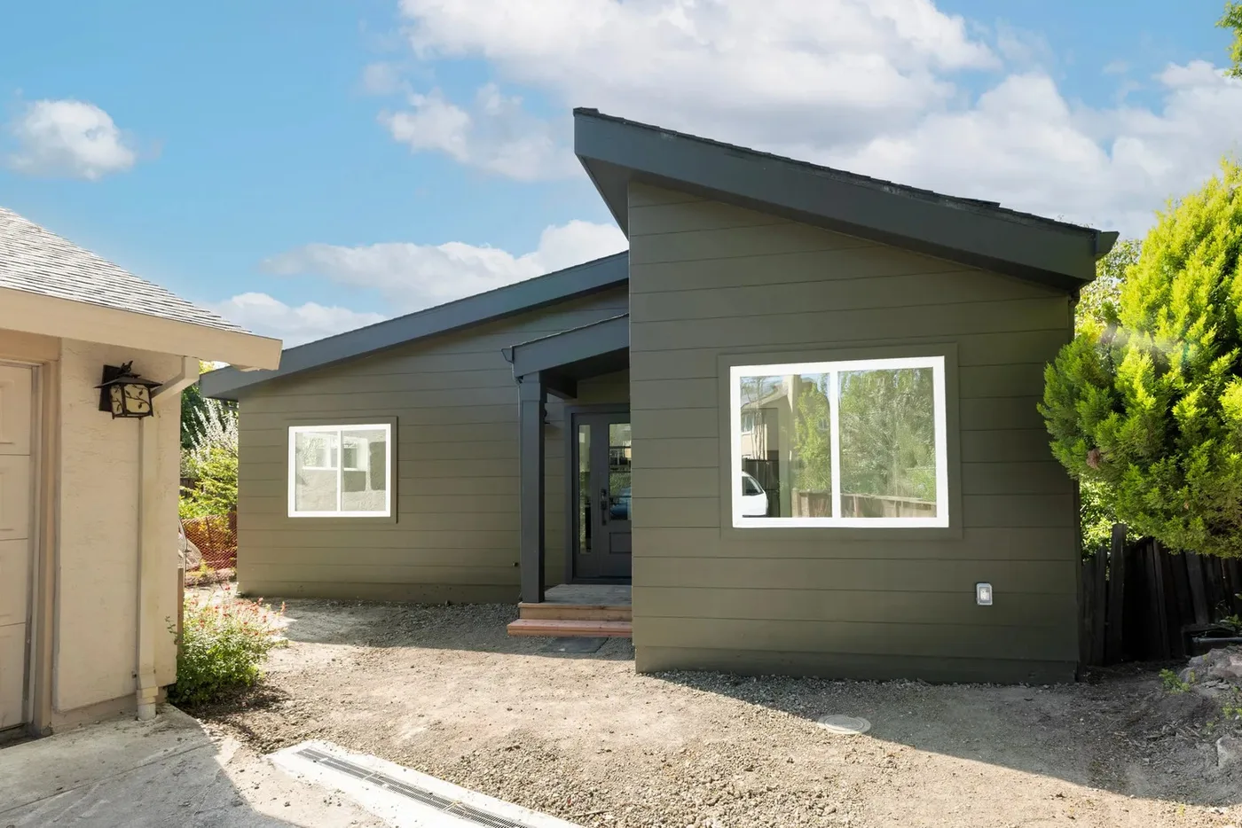 The finished 490 sq ft ADU with its slanted roofline and covered entry, tucked beside the main house — Danville ADU Foundation, Danville, CA