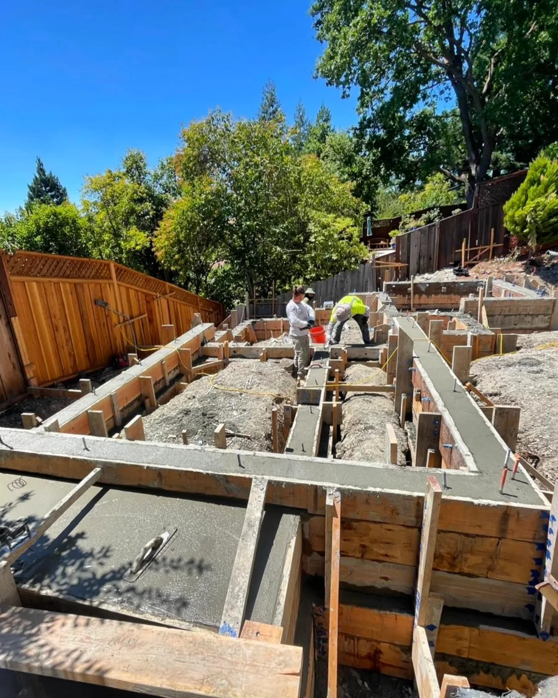The crew placing concrete in the stem-wall forms — Danville ADU Foundation, Danville, CA