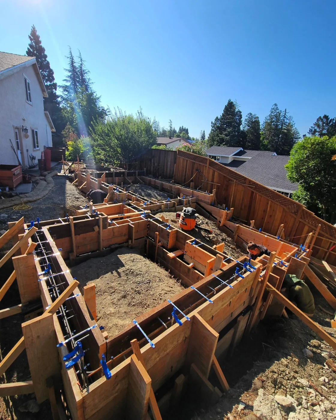Elevated view of the full formwork layout beside the main house — Danville ADU Foundation, Danville, CA