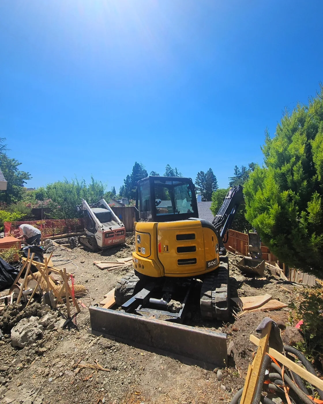 Mini excavator and skid steer digging the hillside site — Danville ADU Foundation, Danville, CA