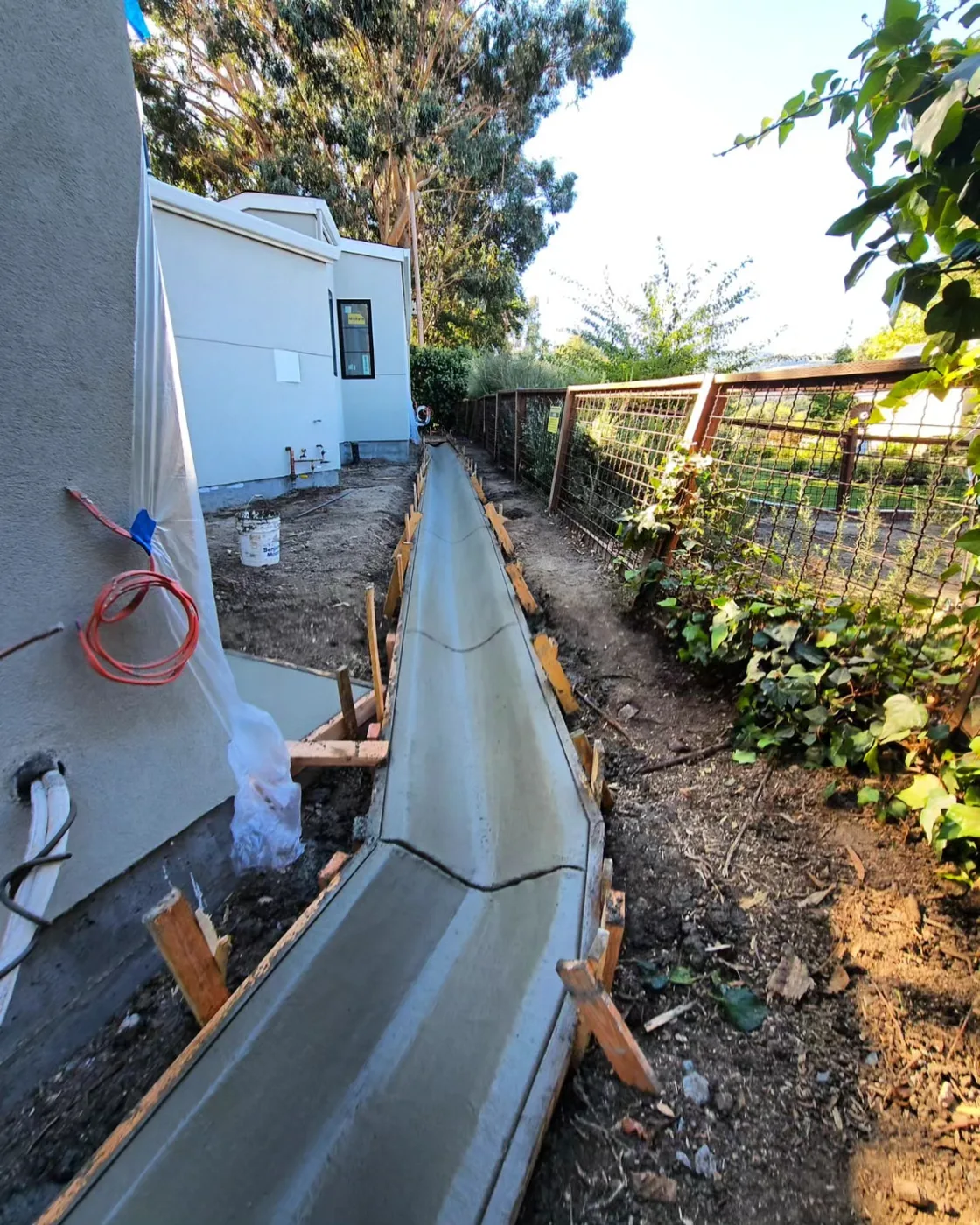 Freshly finished V-profile drainage channel running the side yard between the house and fence — Danville Landing Pad & Curb Drainage, Danville, CA