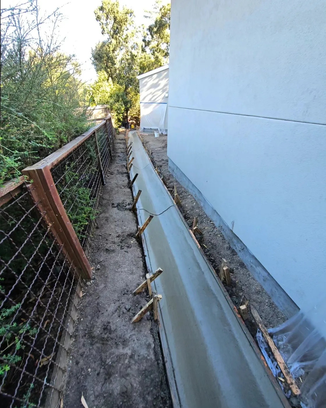 Long view of the finished drainage channel running the length of the side yard — Danville Landing Pad & Curb Drainage, Danville, CA