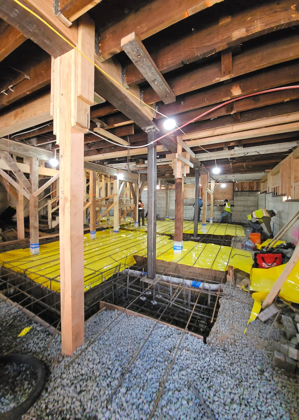 Vapor barrier and slab rebar going down over the new basement footprint — Durant Basement Foundation, Berkeley, CA