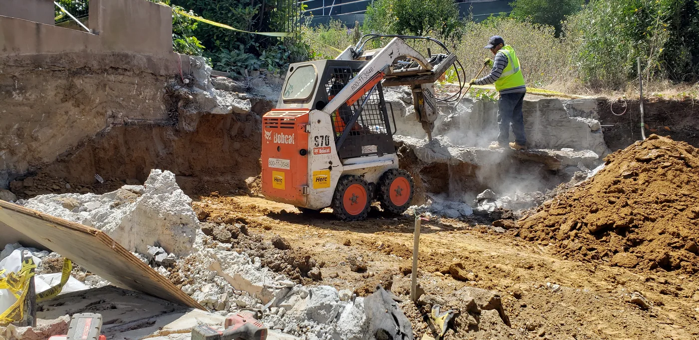 Excavating into the hillside with a skid-steer under tight urban access — Lombard Street Basketball Court Foundation, San Francisco, CA