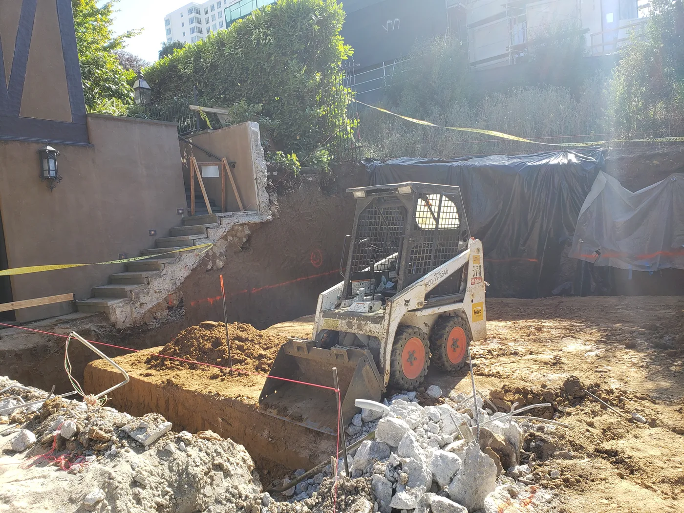 Clearing excavated rock and rubble on the hillside site — Lombard Street Basketball Court Foundation, San Francisco, CA