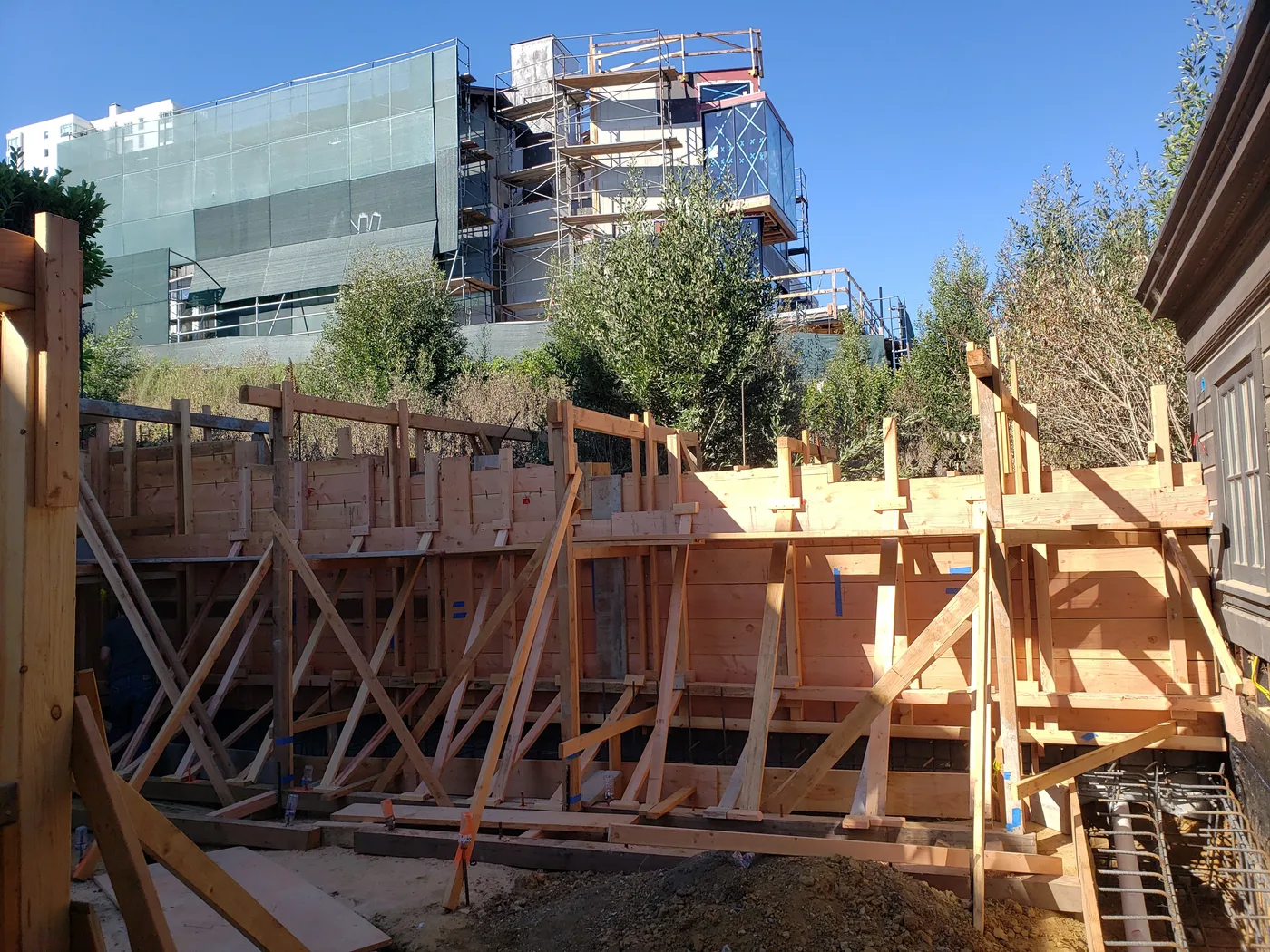 Heavily braced retaining-wall forms on the hillside — Lombard Street Basketball Court Foundation, San Francisco, CA
