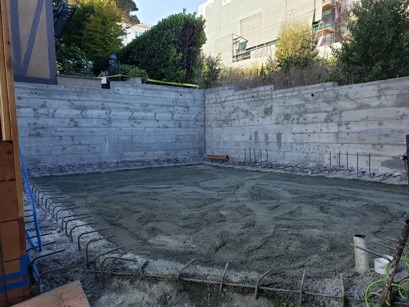 Stripped concrete retaining walls around the court pad — Lombard Street Basketball Court Foundation, San Francisco, CA