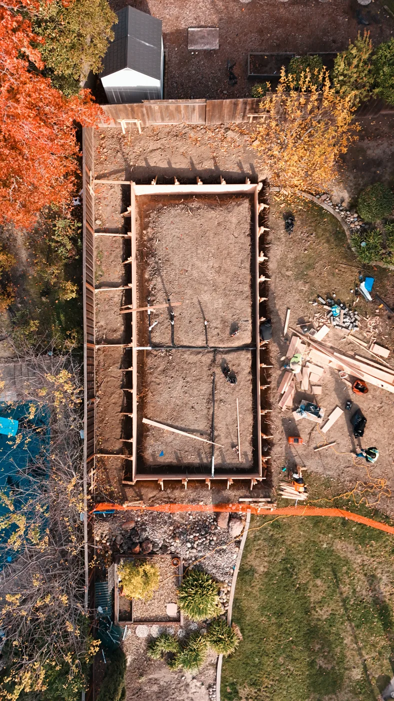 Top-down aerial of the formed ADU footprint with the underslab plumbing laid out — Moraga Backyard ADU, Moraga, CA