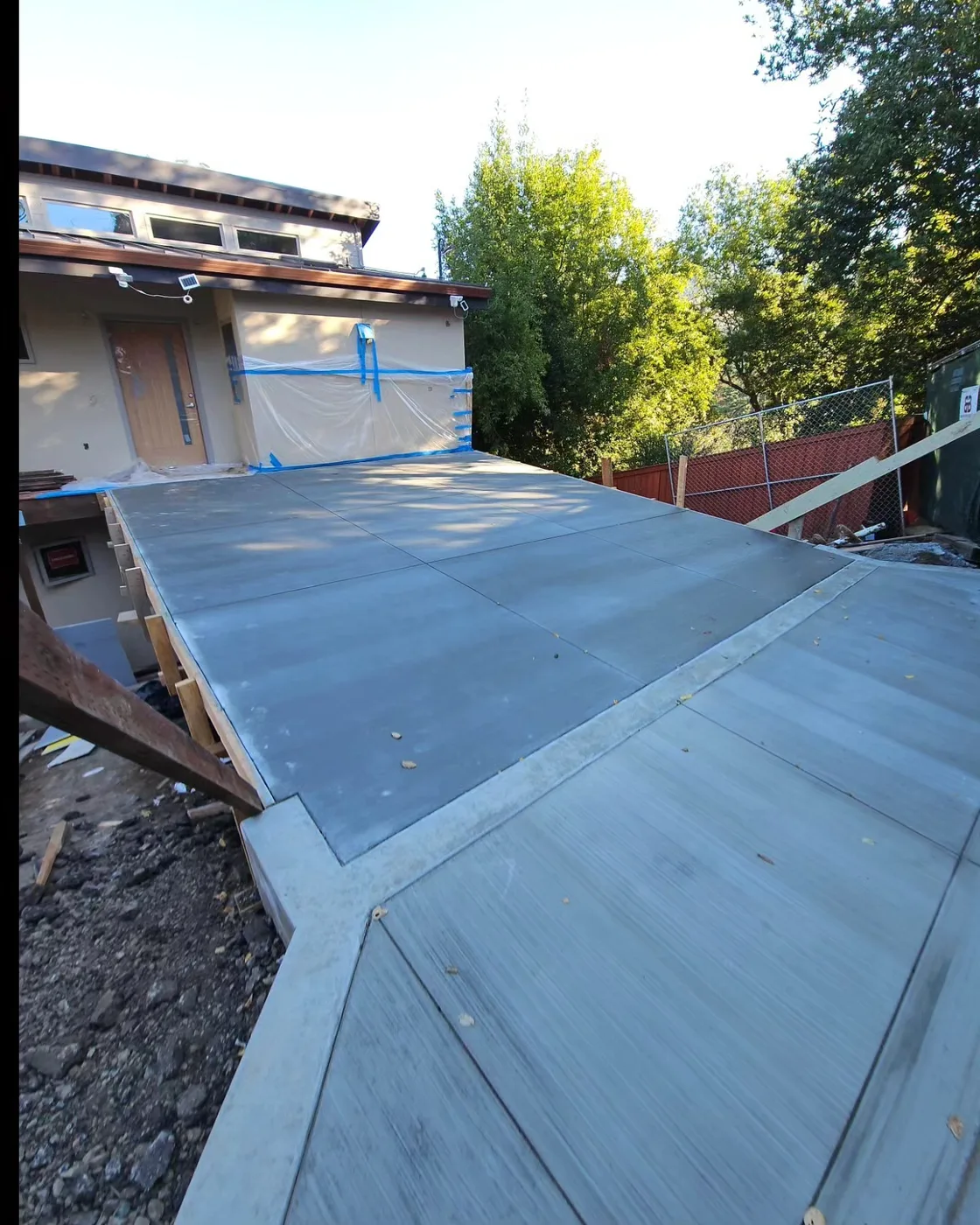 The smooth-finished concrete driveway deck spanning to the house before railings — Richmond, CA