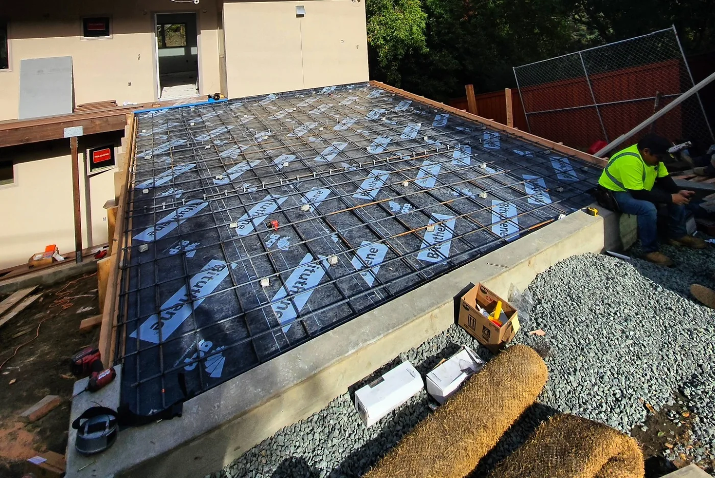 The waterproofed, rebar-matted deck ready for the concrete pour, crew at the edge — Richmond Bridge Driveway, Richmond, CA