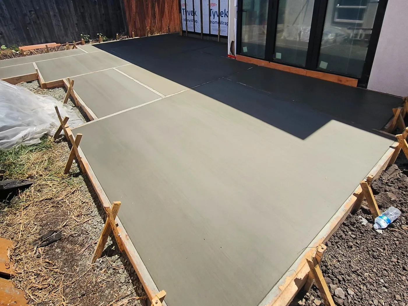 Freshly poured concrete patio panels curing in the forms — Richmond Outdoor Patio, Richmond, CA