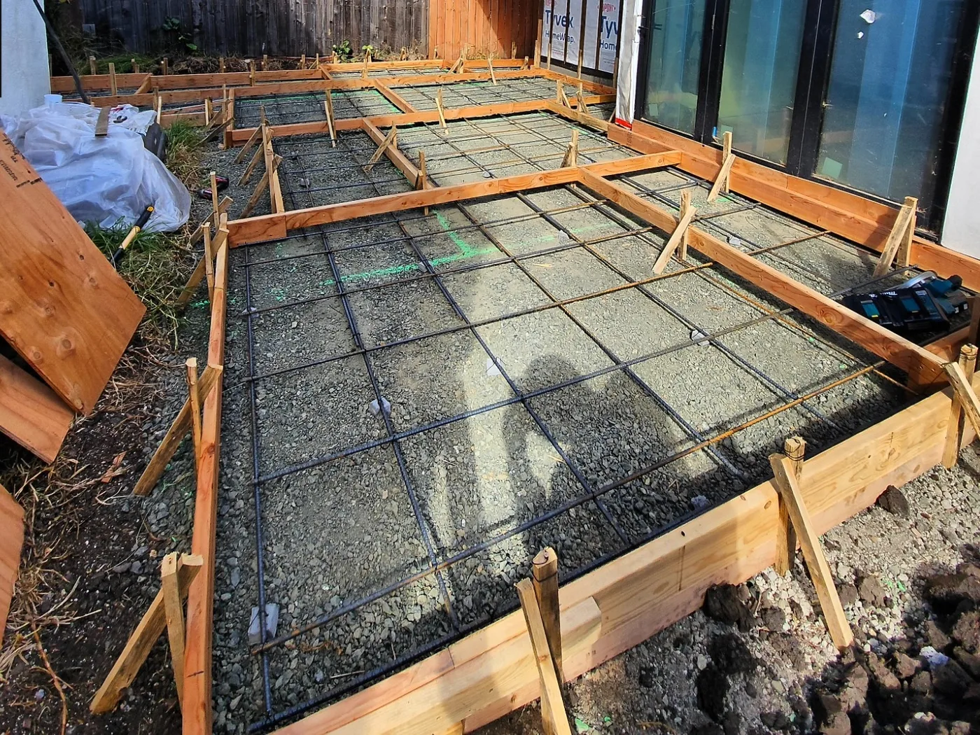 Reinforcing-steel grid set in the forms over the gravel base before the pour — Richmond Outdoor Patio, Richmond, CA
