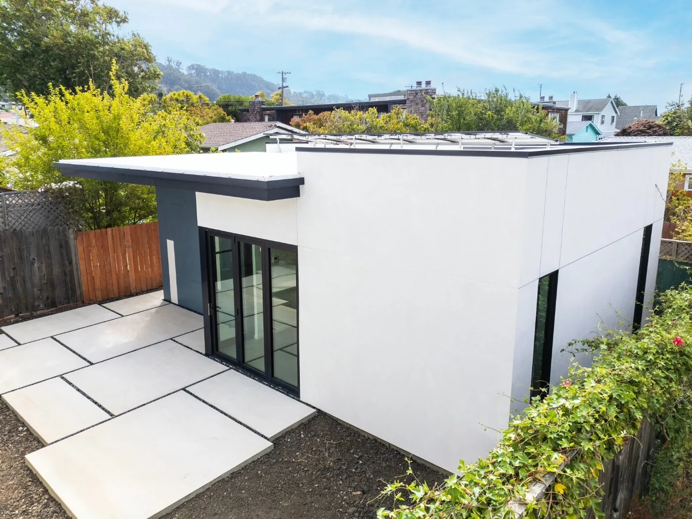 The finished patio and modern home from above, hills beyond — Richmond Outdoor Patio, Richmond, CA